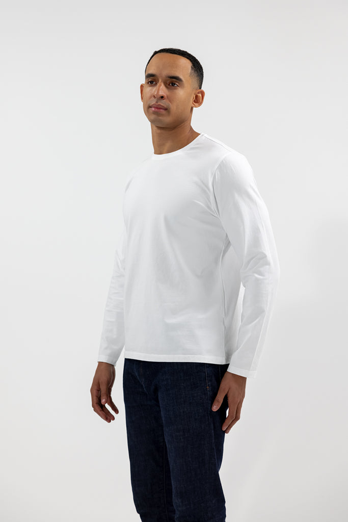 side view of model wearing Easy Mondays off white colored long sleeved crew neck sweatshirt