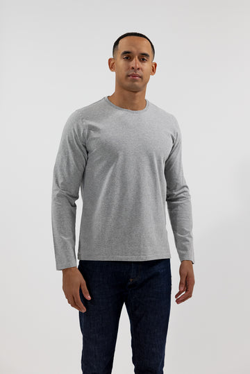 front of model wearing Easy Mondays light grey heather colored long sleeved crew neck sweatshirt