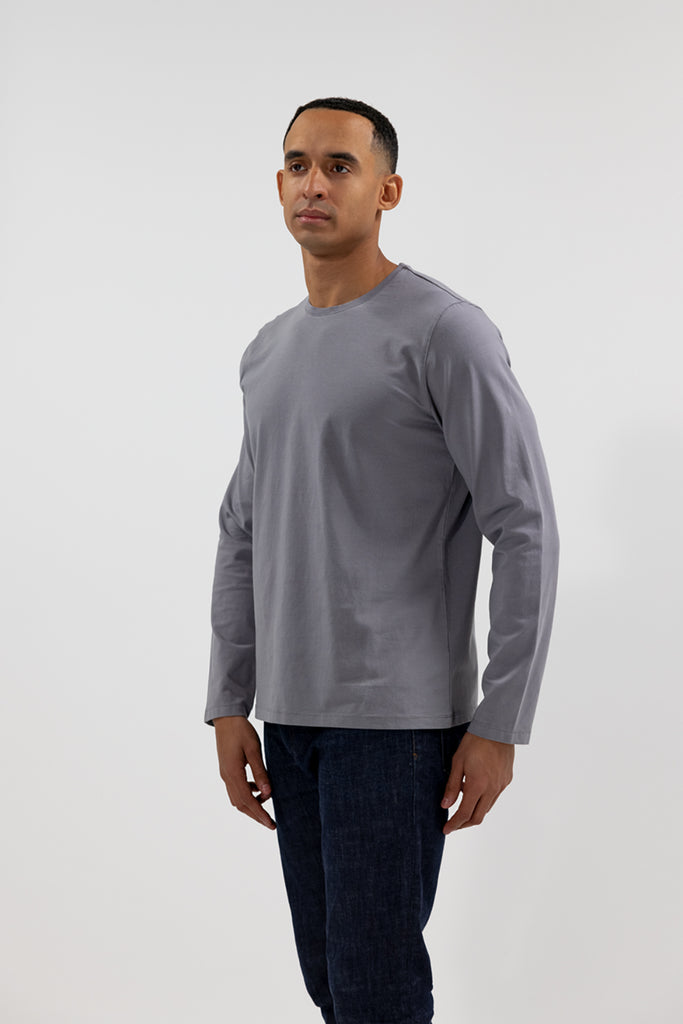 angled side view of model wearing Easy Mondays medium grey slate colored long sleeved crew neck sweatshirt