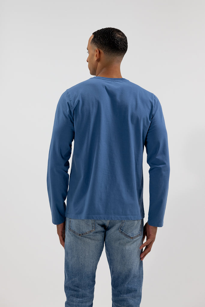 back view of model wearing Easy Mondays medium ocean blue colored long sleeved crew neck sweatshirt