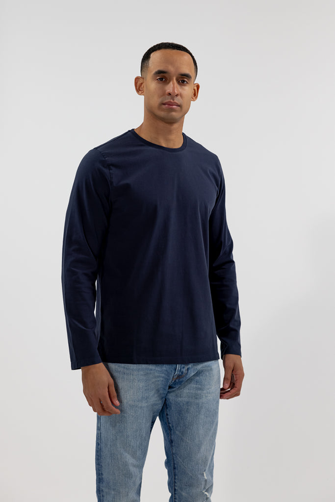 angled front view of model wearing Easy Mondays dark blue navy colored long sleeved crew neck sweatshirt