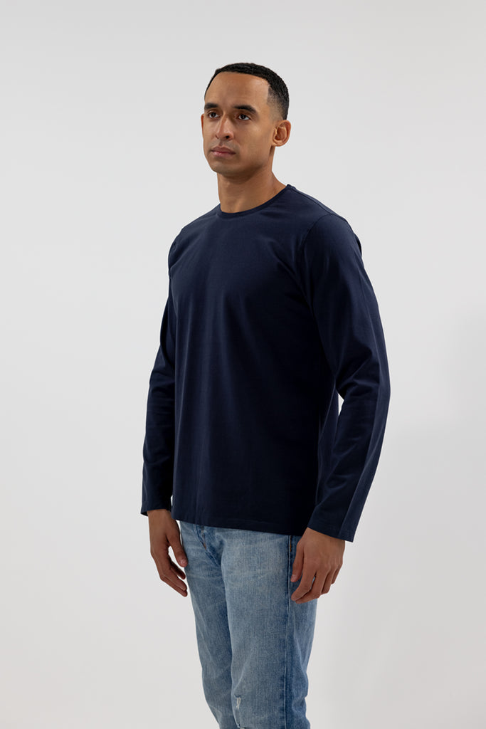angled side view of model wearing Easy Mondays dark blue navy colored long sleeved crew neck sweatshirt