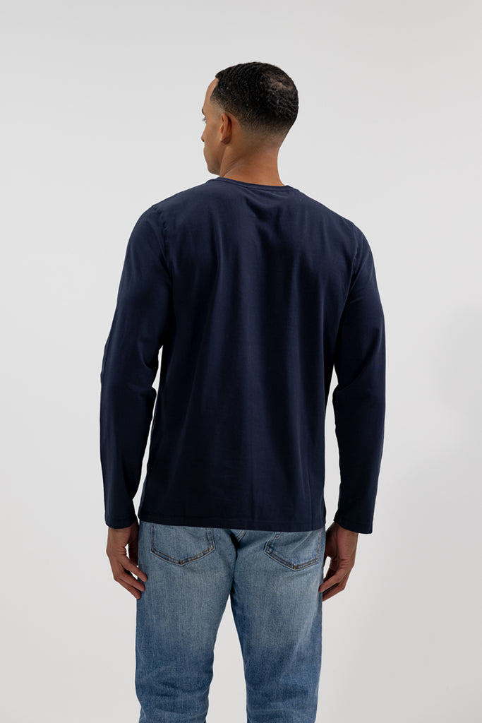 back view of model wearing Easy Mondays dark blue navy colored long sleeved crew neck sweatshirt