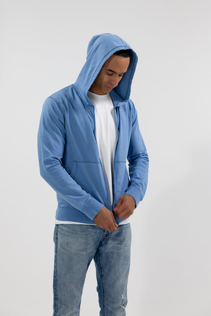angled side view of model wearing Easy Mondays light sky blue hoodie jacket