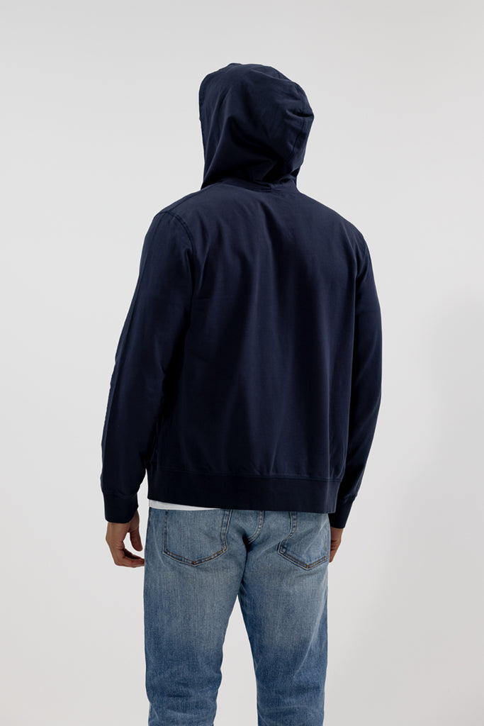 back view of model wearing Easy Mondays dark blue navy hoodie jacket with hood on