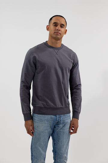 front view of model wearing Easy Mondays black long sleeved crew neck sweatshirt