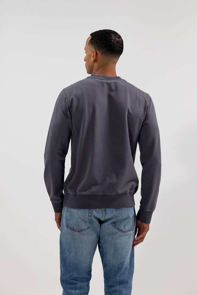 back view of model wearing Easy Mondays black long sleeved crew neck sweatshirt
