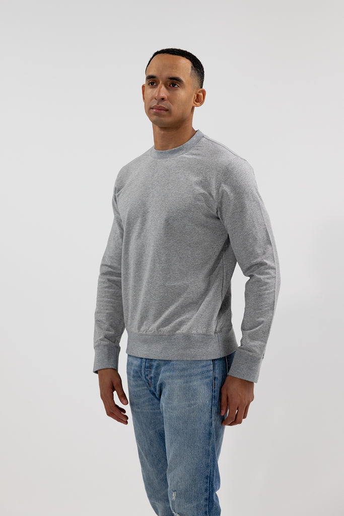 alternative angled front view of model wearing Easy Mondays crew neck sweatshirt in light grey heather color