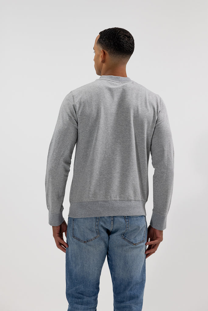 back view of model wearing Easy Mondays crew neck sweatshirt in light grey heather color