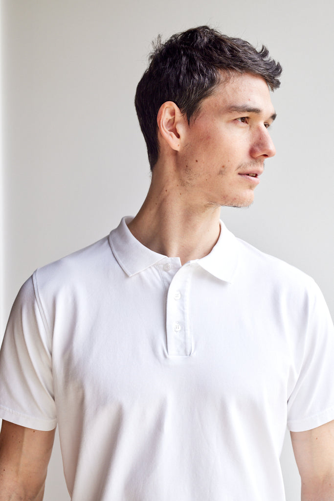alternative close up front view of model wearing Easy Mondays off white colored polo shirt with color-matched buttons