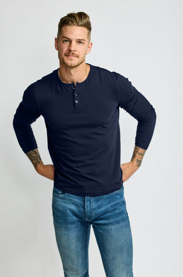 front of model wearing Easy Mondays brand Henley shirt in dark blue navy color with color matched buttons