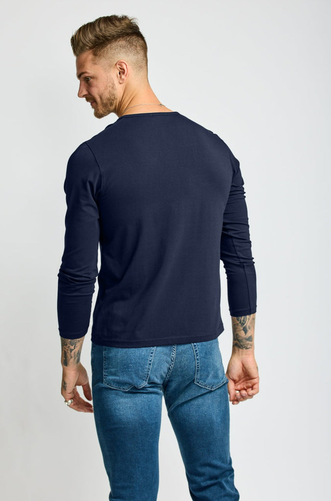 back of model wearing Easy Mondays brand Henley shirt in dark blue navy color with color matched buttons