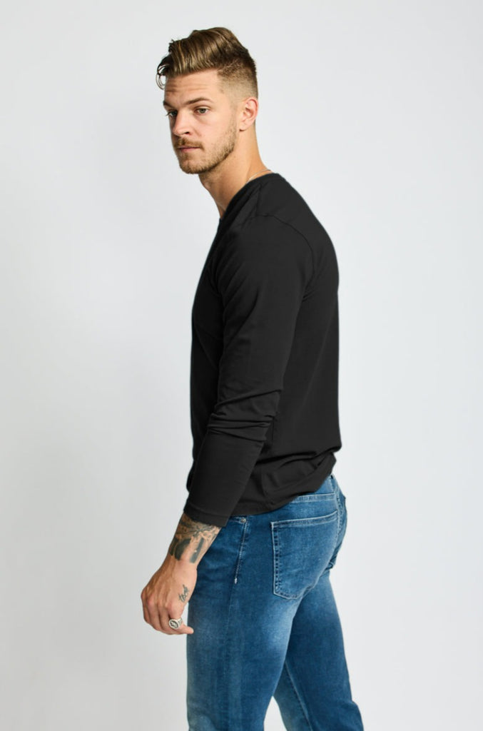 side view of model wearing Easy Mondays brand black v neck tee shirt