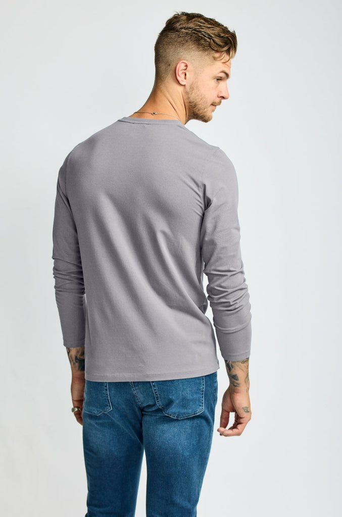 back of  model wearing Easy Mondays brand v neck long sleeved shirt in medium grey slate color