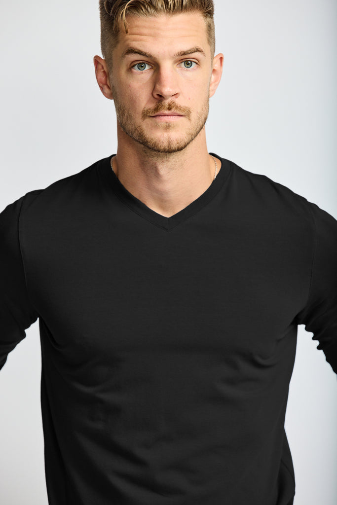 close up of front of model wearing Easy Mondays brand black v neck tee shirt