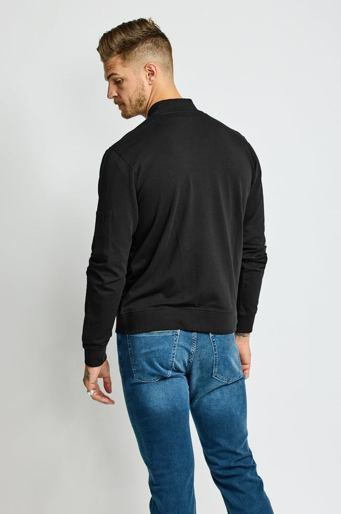 back of model wearing Easy Mondays brand full-zip black fleece bomber jacket