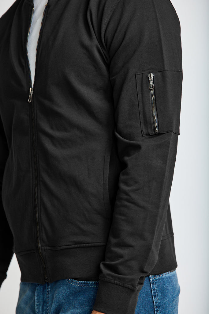 close up of side view of model wearing Easy Mondays brand full-zip black fleece bomber jacket 