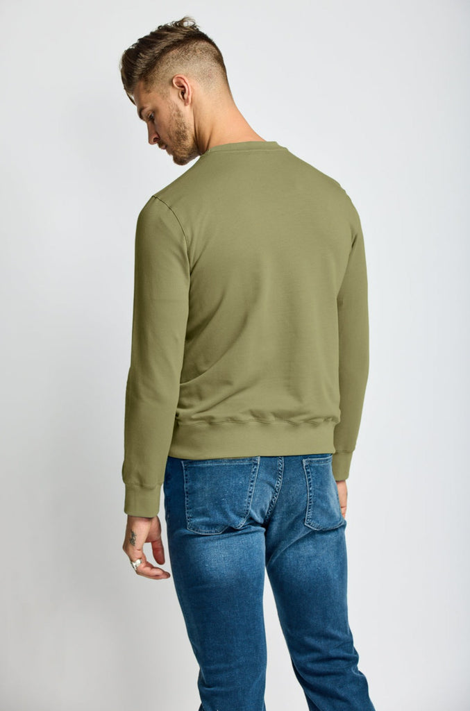 back of model wearing Easy Mondays brand crew neck sweatshirt in light forest green sage color