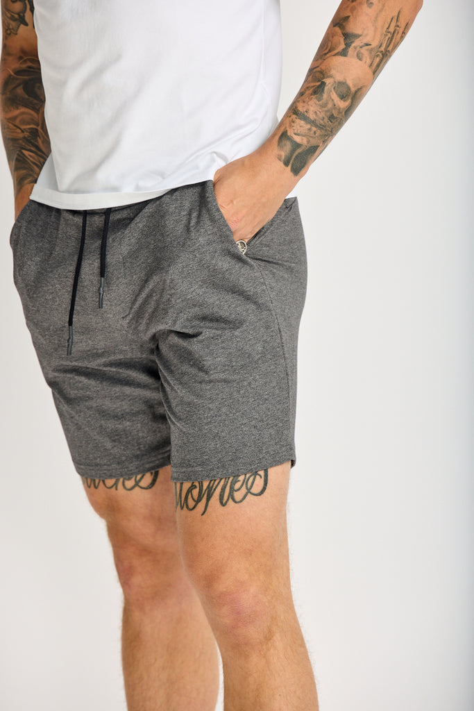 angled side view of bottom half of model wearing Easy Mondays lightweight terry sweatshort in medium grey charcoal color