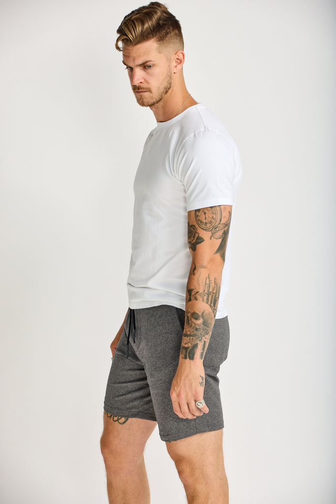angled side view of model wearing Easy Mondays lightweight terry sweatshort in medium grey charcoal color