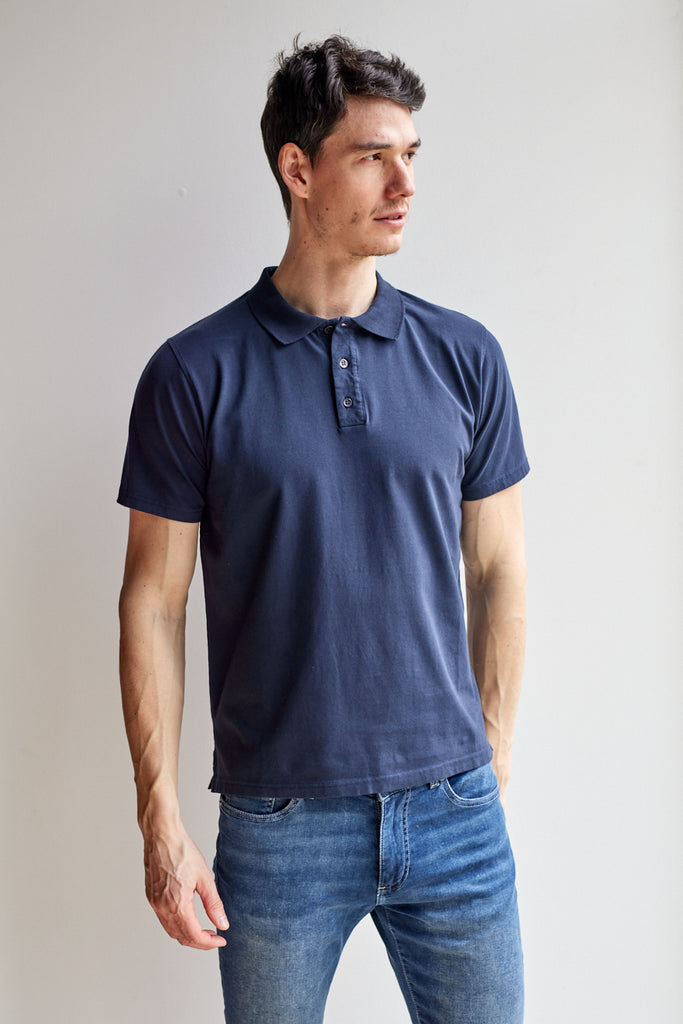 front view of model wearing Easy Mondays dark blue navy colored polo shirt with color-matched buttons