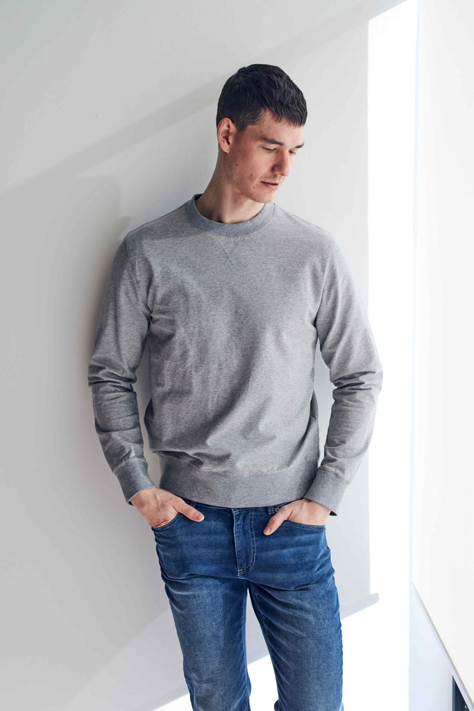 front view of model wearing Easy Mondays crew neck sweatshirt in light grey heather color